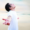 Young Man Looking Up with Arms Raised Portrait